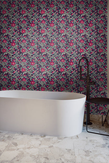 Bright crimson flower and silver buds on dark blue wallpaper close-up