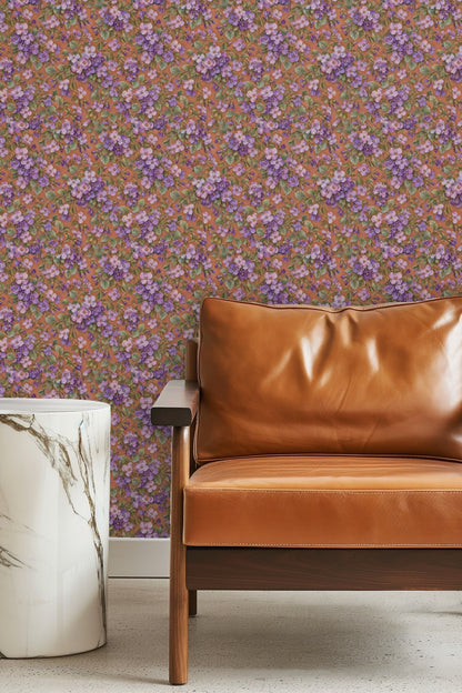 Detailed view of Aubrieta Violet Cascade wallpaper showing clusters of purple aubrieta flowers and green leaves on terracotta background