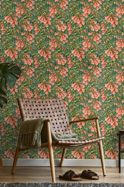 Botanical wallpaper layering green leaves and coral trumpet flowers artistically.