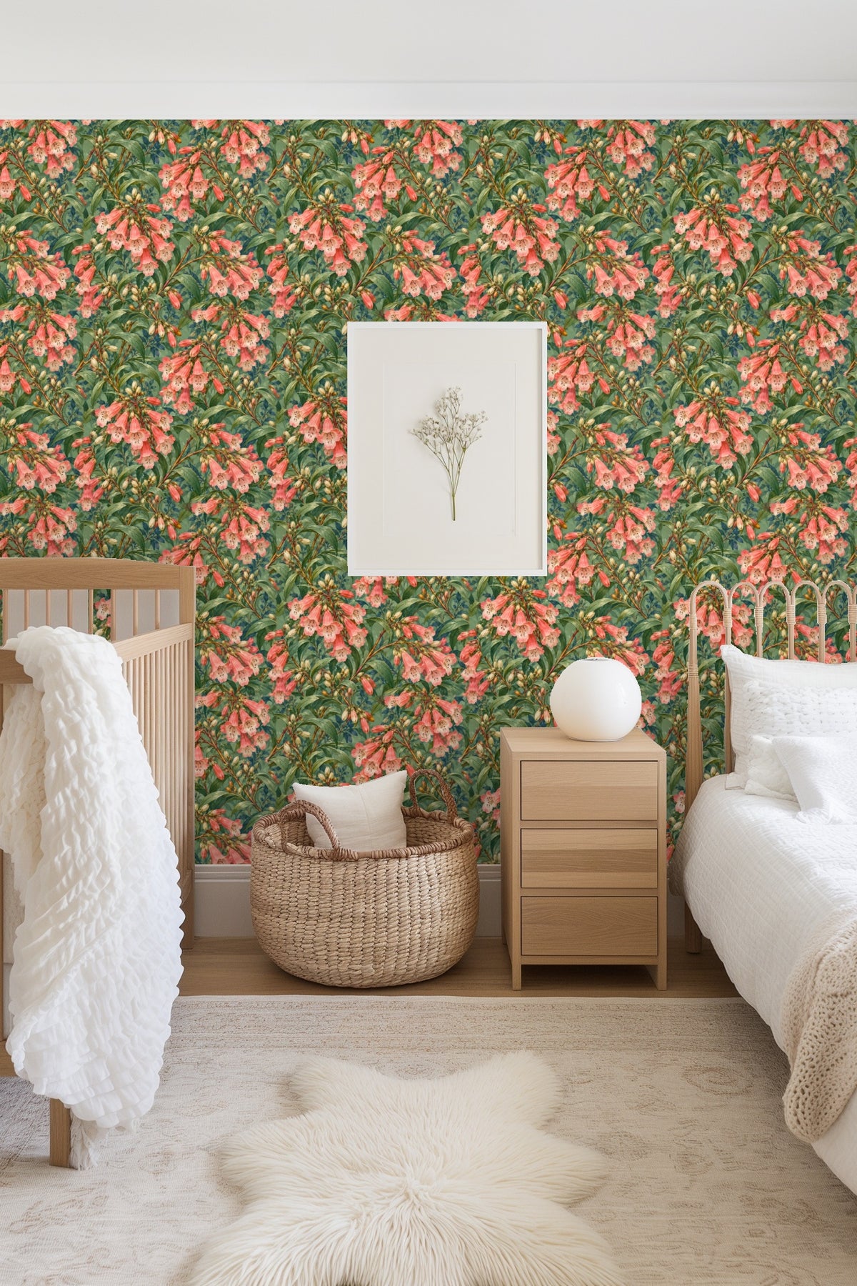 Emerald green sofa with blue pillow and gold table in front of coral penstemon floral wallpaper.