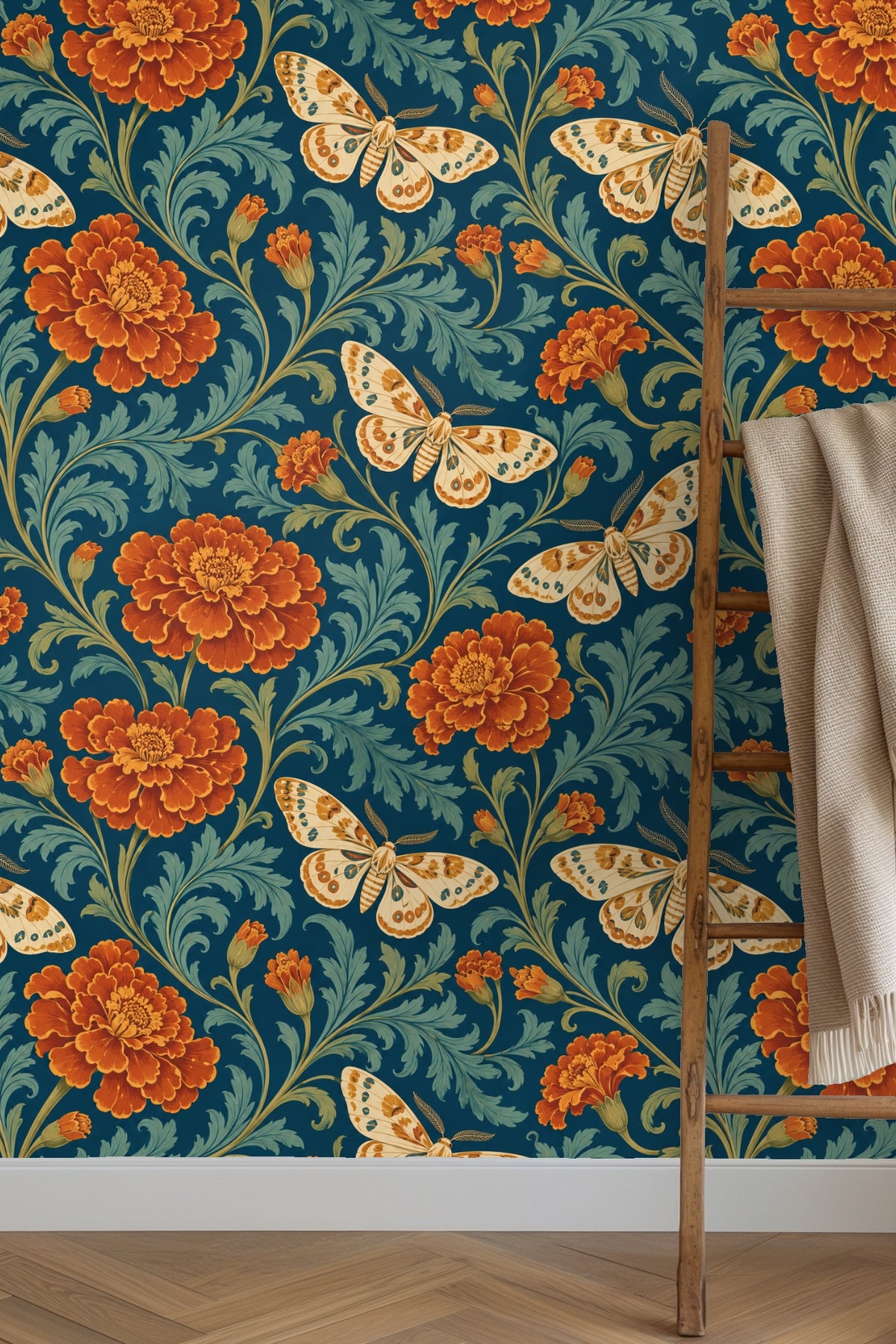 Close-up of a single cream moth with rust and teal markings flying among rust marigold flowers and teal foliage