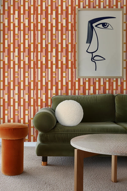Geometric wallpaper with terracotta, ochre, pink, cream, and maroon rectangles in a stacked ladder pattern.