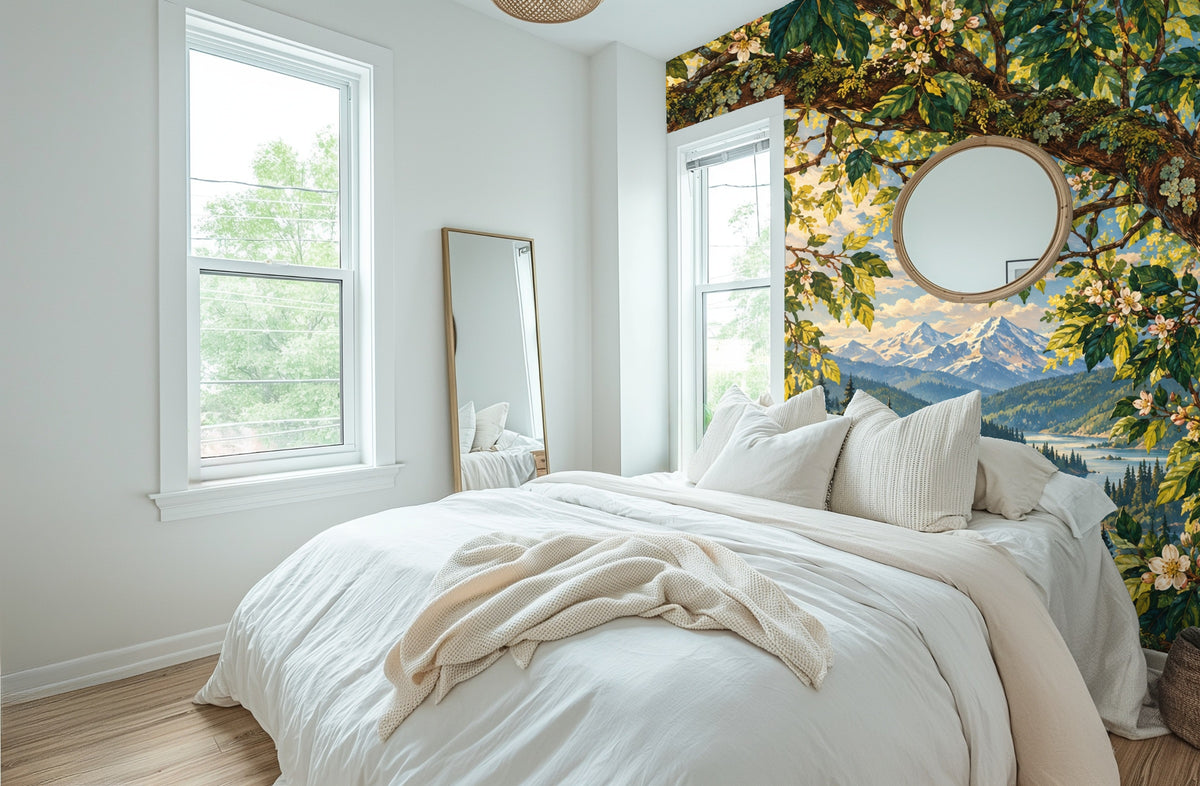 Bedroom vignette: mural behind a neutral bed showing branches, blossoms and distant blue peaks
