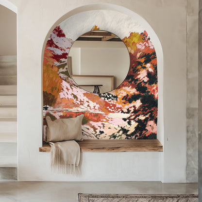 Large-scale installation behind a contemporary bench, wall mural in warm pinks and rusts creating an immersive entryway focal point