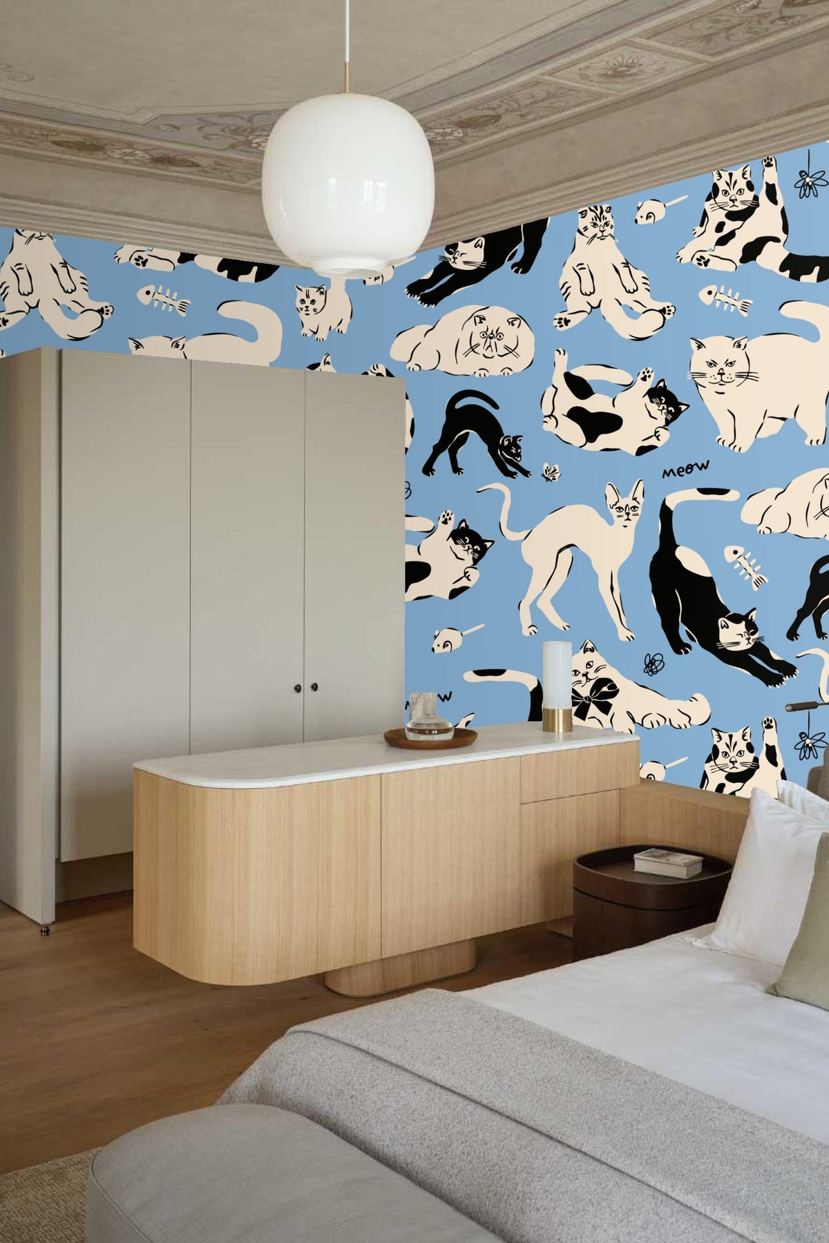Detail of hand-drawn fish bone and mouse toys scattered on wallpaper