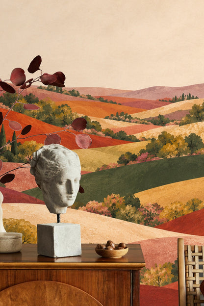 Muted pastel sky above the terracotta and olive patchwork hills in wallpaper composition.
