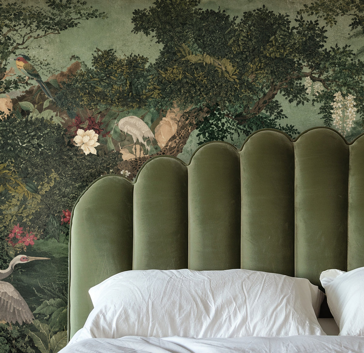 Living room feature wall with Verdant Court mural behind a charcoal sectional and coral accent chair demonstrating scale and contrast.