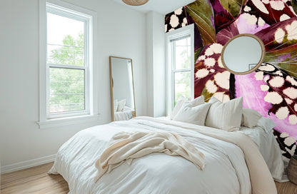 Large-scale Begonia Nocturne mural in a modern arched living room, wall-to-wall floral leaves in burgundy and pink