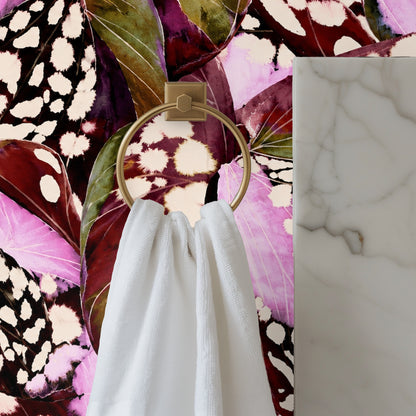 Ceiling-to-wall view of the wallpaper’s oversized leaves and spotted motifs wrapping a contemporary living space