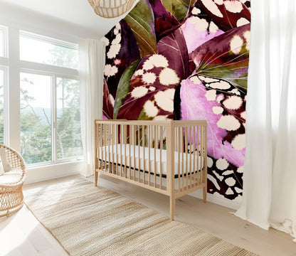 Bathroom detail showing wallpaper behind a towel ring, highlighting olive veins and cream spots on the leaves