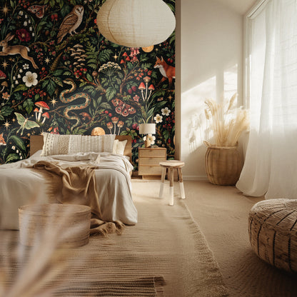 Bedroom scene with the wallpaper as a headboard wall; warm natural textiles contrast the dark botanical print.
