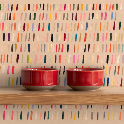 Close perspective of the wall showing neat rows of tiny painted strokes in jewel and pastel tones