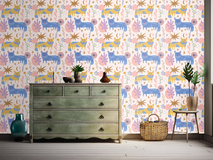 Full repeat pattern showing blue and mustard cat silhouettes with stars and botanical shapes on a pale pink field.