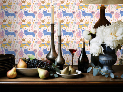 Lifestyle vignette: dresser and plants against a feature wall covered in the Cat pattern, showing scale and furniture pairing.