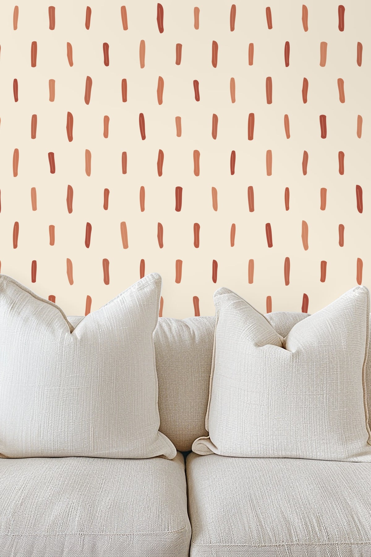 Nursery room featuring wallpaper with vertical terracotta brushstrokes behind a light wooden crib.