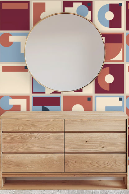Curated workspace with geometric wallpaper providing an artistic, structured energy infused with soft blue and burgundy blocks.