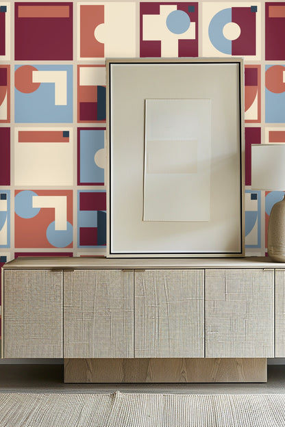 Close-up detail of wallpaper pattern showing contrasting large shapes and circular motifs in warm and cool color juxtaposition.