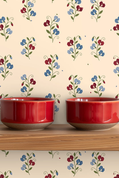 Soft cream base with evenly spaced delicate sweetpea flowers in blue and red tones.
