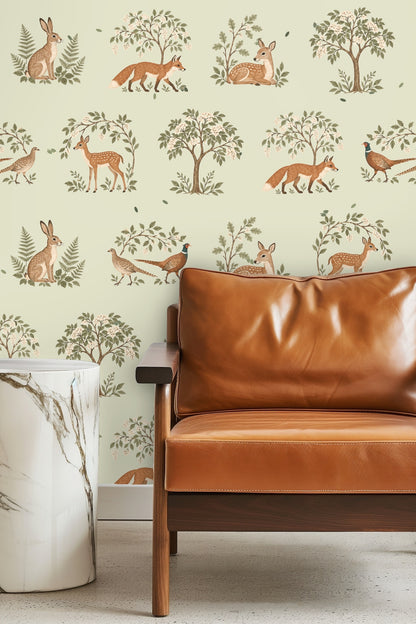 Bedroom scene with a natural wood headboard and Woodland Reverie Wallpaper behind, showcasing soft green and warm animal motifs.