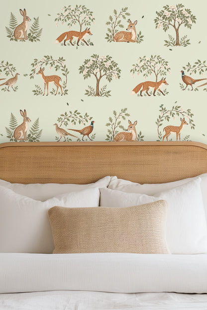 Detailed close-up of wallpaper showing fawn, fox, rabbit, pheasant, trees, and leaves on sage background.