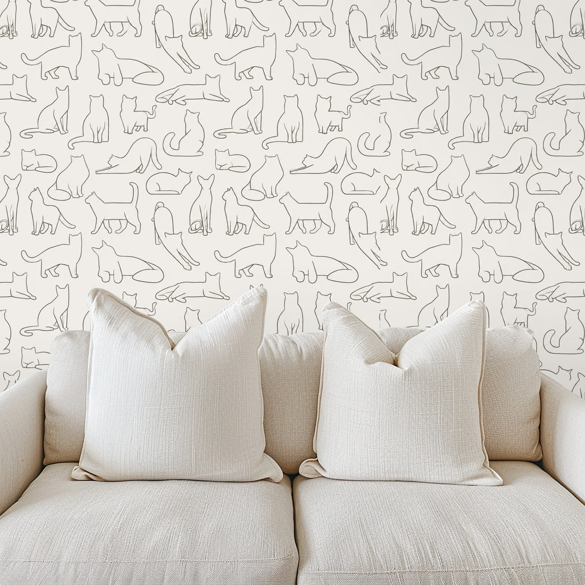 Close-up of wallpaper showing small-scale hand-drawn cat outlines in warm gray on a cream background