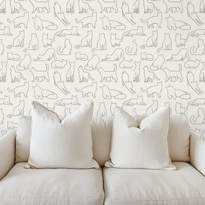 Close-up of wallpaper showing small-scale hand-drawn cat outlines in warm gray on a cream background