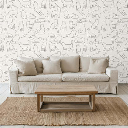 Blue velvet sofa placed in front of wallpaper, highlighting the warm graphite cat linework