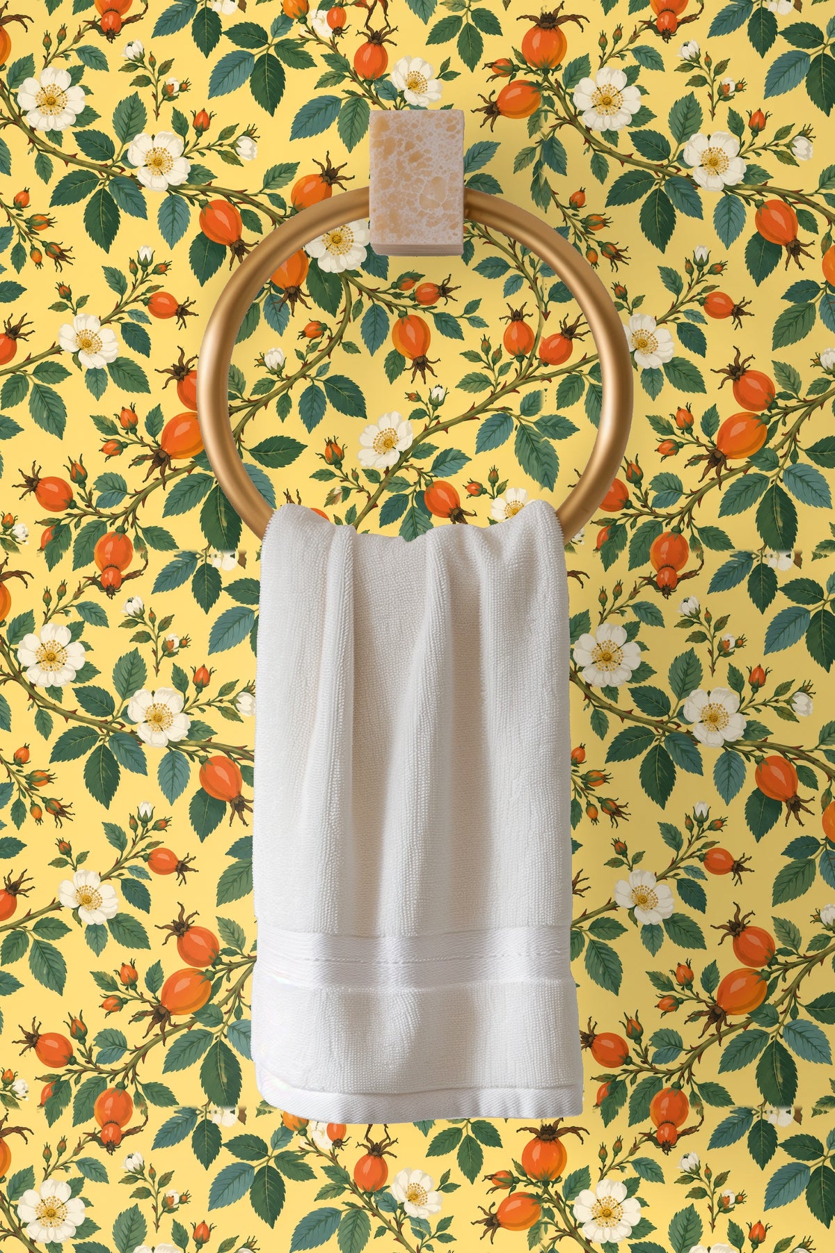 Decorative ladder with beige throw in front of rosehip patterned wallpaper