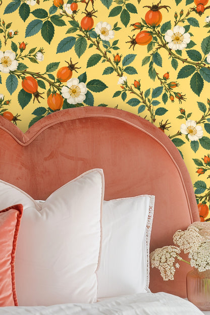 Bedroom corner showing green bed and rosehip wallpaper
