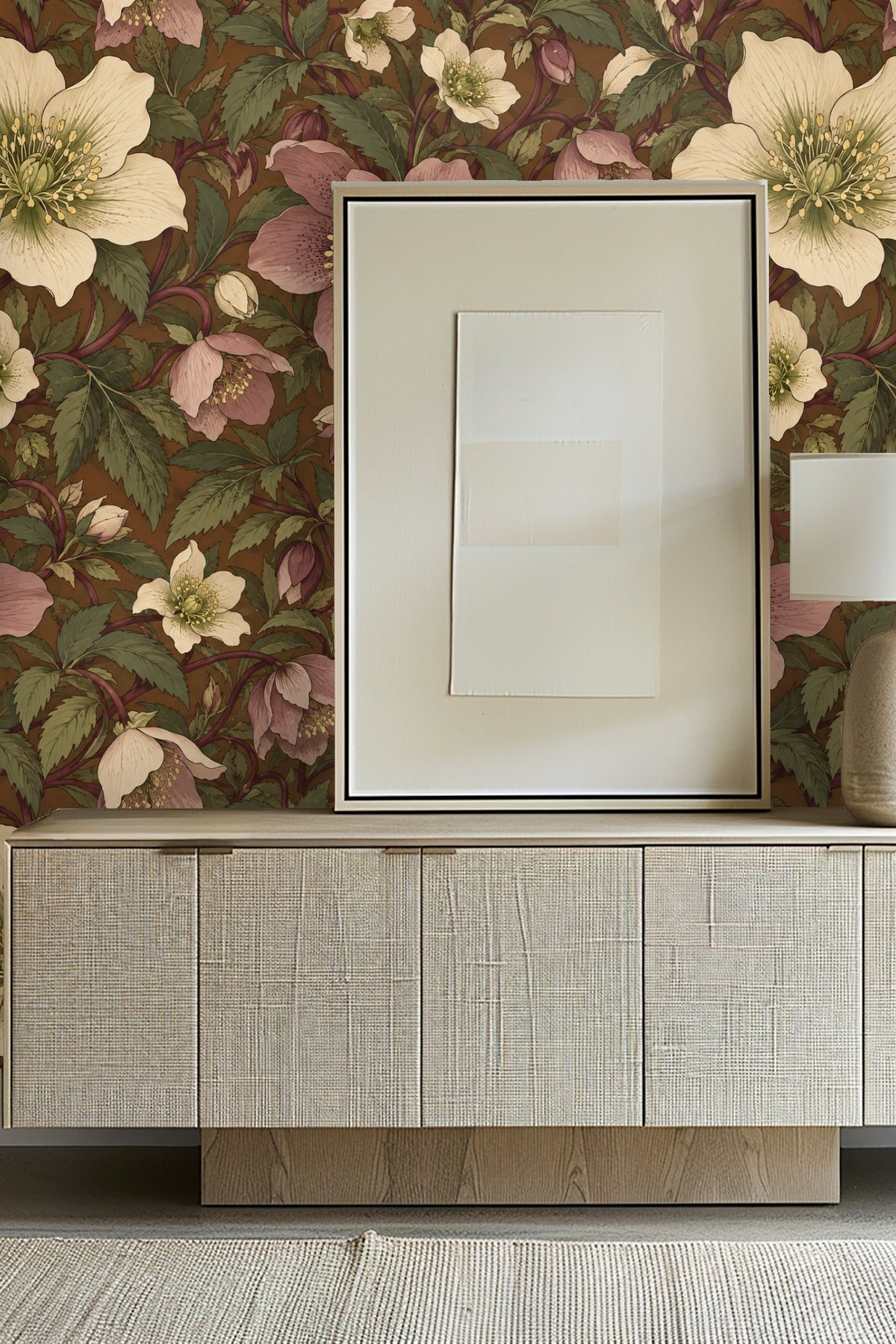 Detailed view of overlapping cream and pink hellebore flowers and green leaves on wallpaper.