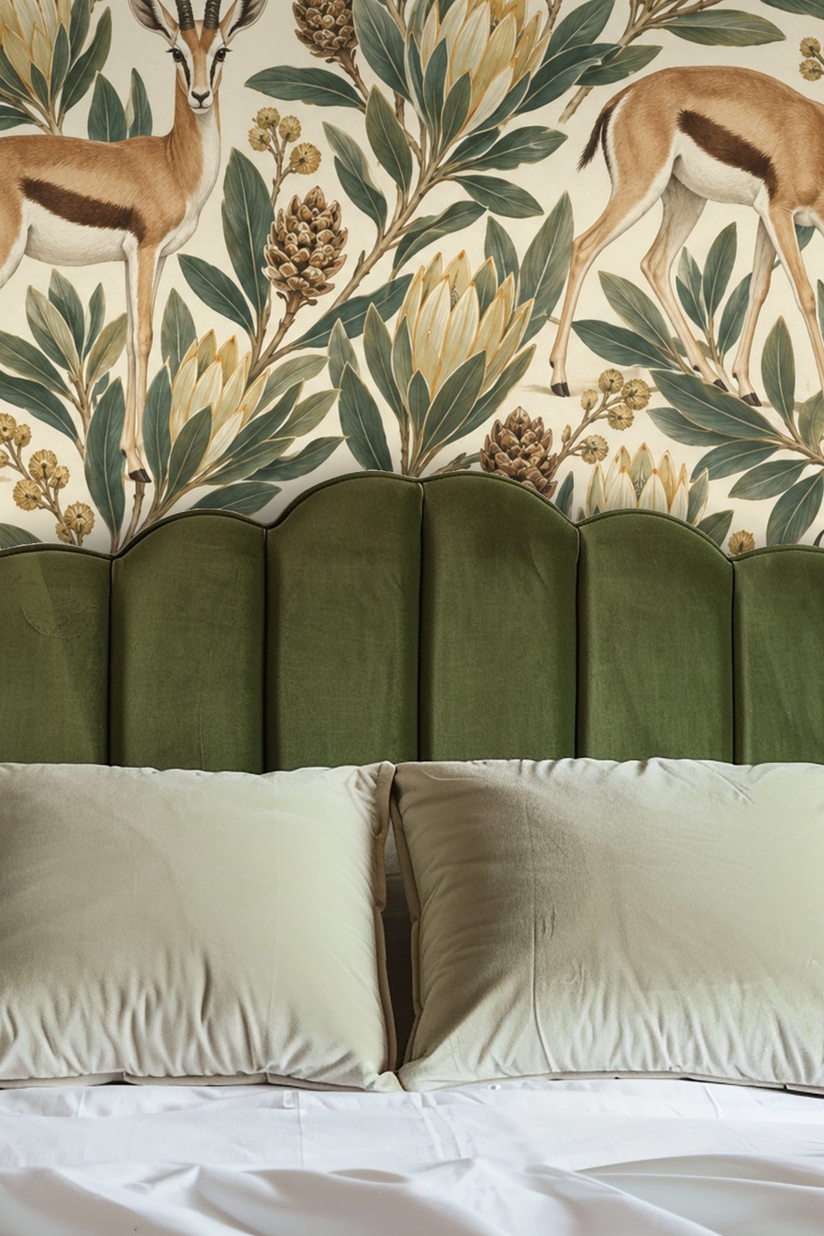 Entryway wall decorated with wallpaper showing springboks and lush protea foliage behind a circular mirror and wooden bench.