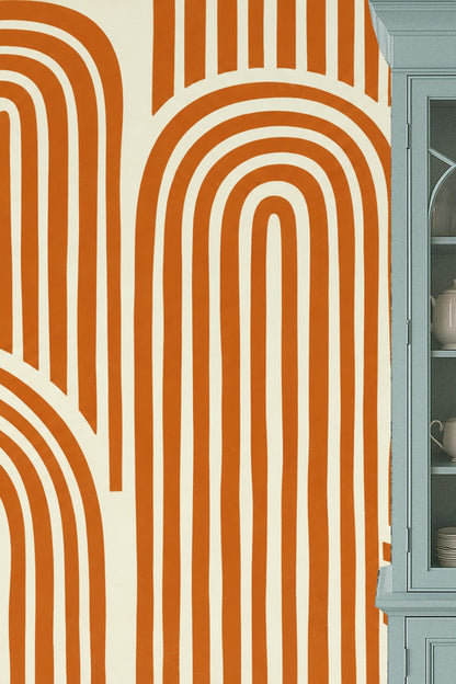 Close-up detail of repeating terracotta arches on cream ground