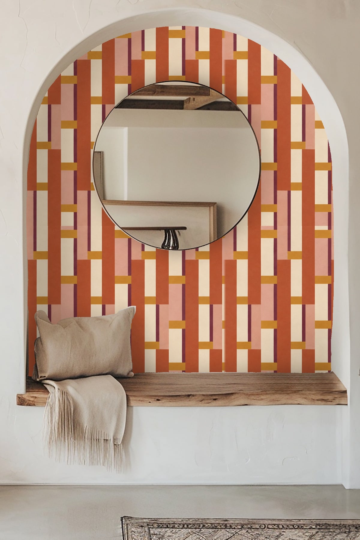Close-up of leather chair against terracotta and rose geometric wallpaper with clean vertical lines