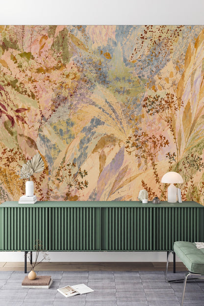 Dusky Meadow Wallpaper mural behind a white sofa and nesting tables, illustrating soft, painterly wildflower motifs