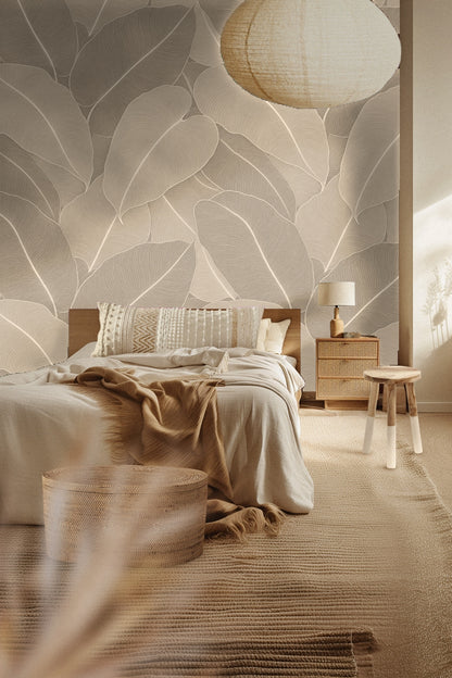 Close-up of large overlapping taupe palm leaves with fine line details in wallpaper pattern