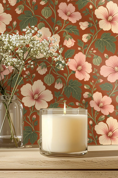 Wallpaper detail behind glass candle and baby's breath flowers showing blush hibiscus and sage green leaves