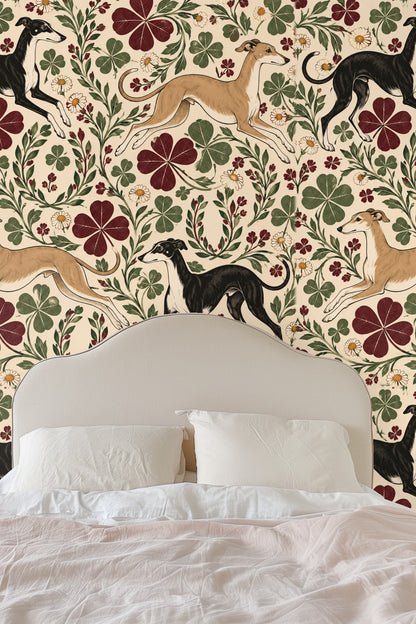 Repeated elements of burgundy four-leaf clovers and green foliage with greyhounds.