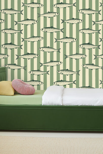 Close-up of side table with candle and vase in front of sardine stripe wallpaper