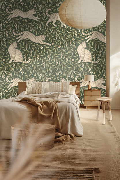 Close-up of wallpaper in bathroom showing tabby cats and leafy botanical pattern behind white towel.