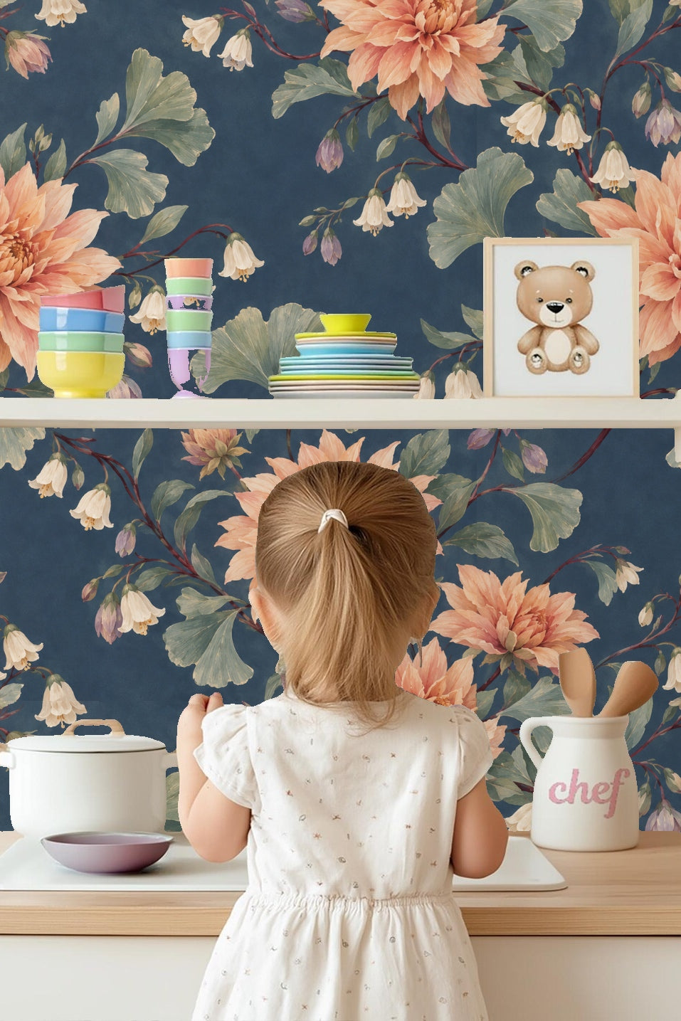 Interior room featuring dusky dahlia wallpaper behind wooden furniture and light hardwood floor.