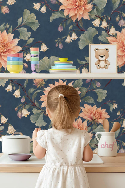 Interior room featuring dusky dahlia wallpaper behind wooden furniture and light hardwood floor.