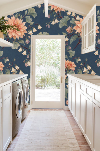 Dahlias and floral vines in coral and cream against deep blue wall.