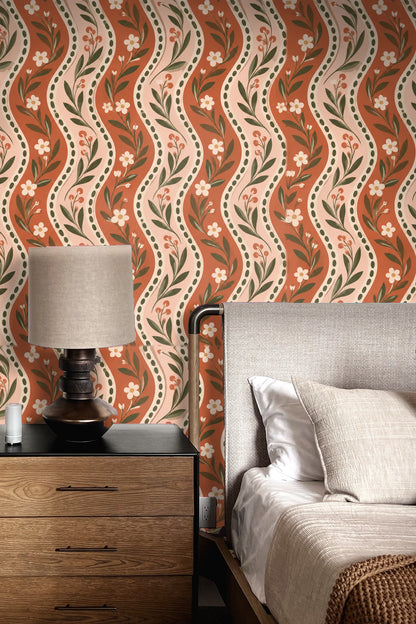 Bedroom wall featuring Rustic Blooms Wave wallpaper behind bed with beige and brown decor