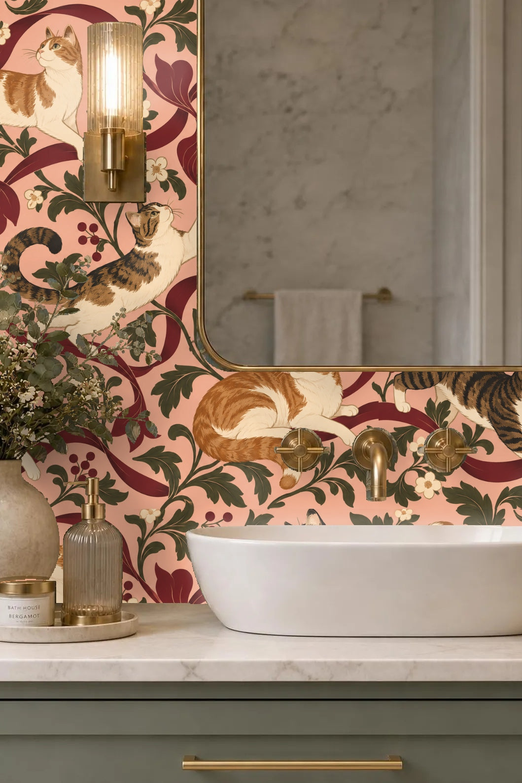 Lounge setting with wallpaper background featuring cats playing on flowing ribbons and leafy branches in muted pink, green, and burgundy.