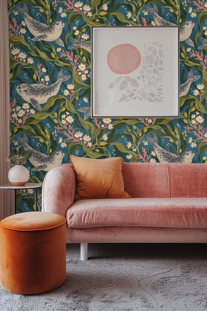 Bedroom with wallpaper mural of harbor seals and kelp behind white sofa with cushions