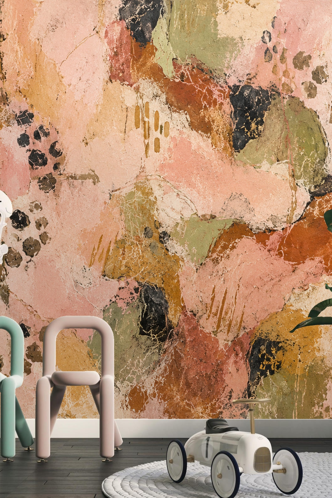 Close-up of textured wallpaper highlighting pink and green layered patches with black marks