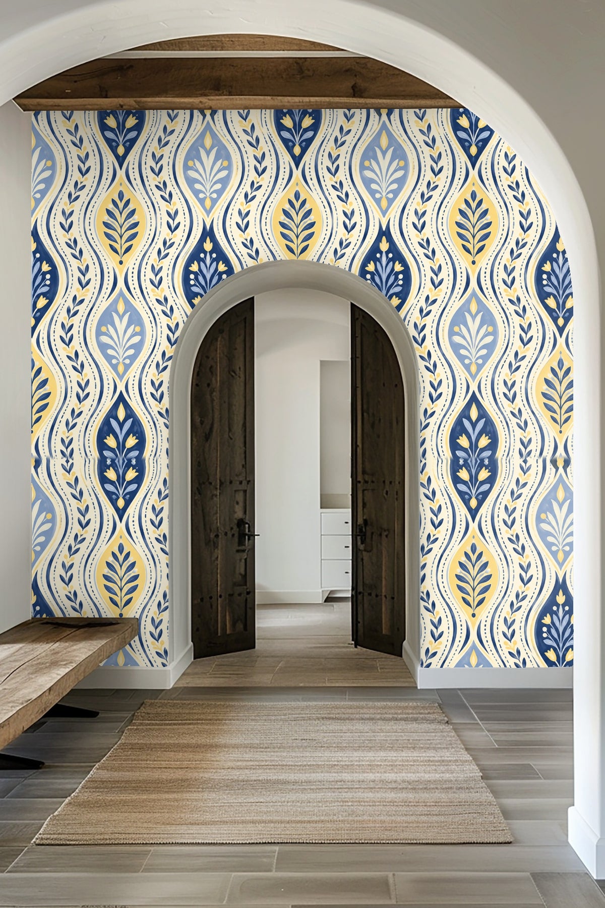 Living room with deep blue velvet sofa in front of botanical wallpaper with wave and leaf pattern