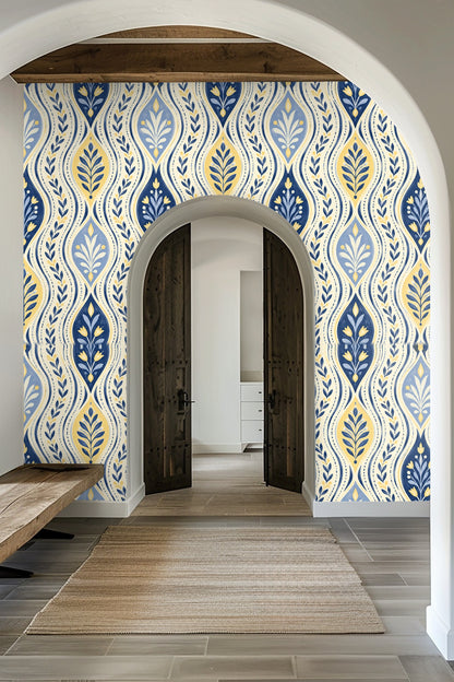 Living room with deep blue velvet sofa in front of botanical wallpaper with wave and leaf pattern