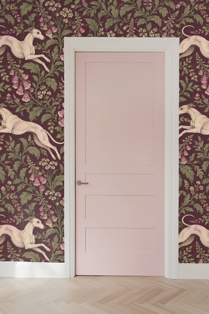 Elegant whippet poses interspersed with leafy botanical elements in wallpaper design.