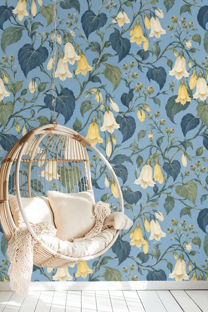 Close-up of bellflower patterned wallpaper with yellow and cream blossoms on blue background